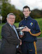 30 October 2010; Ireland captain Eoin Reilly is presented with the Hurling/Shinty U21 International cup by President of the Cananachd, Duncan Cameron. U21 Shinty - Hurling International Final, Ireland v Scotland, Ratoath GAA Club, Ratoath, Co. Meath. Picture credit: Alan Place / SPORTSFILE