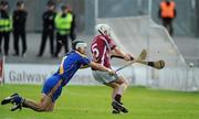 31 October 2010; Paul Coen, Clarinbridge, shoots to score his side's first goal despite the attentions of Damien McClearn. Galway County Senior Hurling Championship Final, Clarinbridge v Loughrea, Pearse Stadium, Galway. Picture credit: Brian Lawless / SPORTSFILE