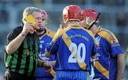 31 October 2010; Referee Michael Dolan issues Tom Regan, Loughrea, with a yellow card. Galway County Senior Hurling Championship Final, Clarinbridge v Loughrea, Pearse Stadium, Galway. Picture credit: Brian Lawless / SPORTSFILE