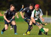 30 October 2010; Neil Heffernan, Ireland, in action against Rory Kennedy and Stevie Stewart, Scotland. U21 Shinty - Hurling International Final, Ireland v Scotland, Ratoath GAA Club, Ratoath, Co. Meath. Picture credit: Alan Place / SPORTSFILE