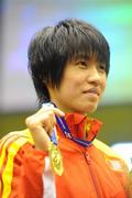 18 September 2010; Cancan Ren, China, after picking up her gold medal following the 51kg Flyweight Final. AIBA Women World Boxing Championships Barbados 2010 - Finals, Garfield Sobers Sports Gymnasium, Bridgetown, Barbados. Picture credit: Stephen McCarthy / SPORTSFILE