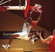 25 August 2001; Ireland's Mike Mitchell hangs from the basket after a slamdunk during the European Basketball Championships Qualifier match between Ireland and Switzerland at the National Basketball Arena in Tallaght, Dublin. Photo by Brendan Moran/Sportsfile