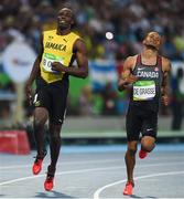 14 August 2016; Usain Bolt of Jamaica after winning the Men's 100m semi-final with second place Andre de Grasse of Canada, right, at the Olympic Stadium during the 2016 Rio Summer Olympic Games in Rio de Janeiro, Brazil. Photo by Stephen McCarthy/Sportsfile