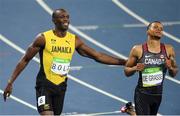 14 August 2016; Usain Bolt of Jamaica after winning the Men's 100m semi-final with second place Andre de Grasse of Canada, right, at the Olympic Stadium during the 2016 Rio Summer Olympic Games in Rio de Janeiro, Brazil. Photo by Ramsey Cardy/Sportsfile