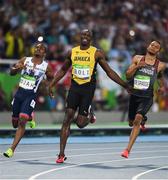 14 August 2016; Usain Bolt of Jamaica after winning the Men's 100m semi-final with second place Andre de Grasse of Canada, right, at the Olympic Stadium during the 2016 Rio Summer Olympic Games in Rio de Janeiro, Brazil. Photo by Stephen McCarthy/Sportsfile