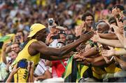 14 August 2016; Usain Bolt of Jamaica celebrates with fans after winning the Men's 100m final at the Olympic Stadium during the 2016 Rio Summer Olympic Games in Rio de Janeiro, Brazil. Photo by Stephen McCarthy/Sportsfile