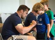 17 August 2016; Leinster Rugby player Cian Healy signs an autograph for Ronan O'Sullivan age 8 from Malahide Dublin at the Bank of Ireland Leinster Rugby Camp at Clontarf FC, Castle Avenue, Clontarf, Dublin. Photo by Eóin Noonan/Sportsfile