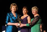 6 November 2010; Kate Kelly, Wexford, is presented with her 2010 Camogie All-Star award by President Mary McAleese and President of the Camogie Association Joan O' Flynn at the 2010 Camogie All-Stars in association with O’Neills. Citywest Hotel, Saggart, Co. Dublin. Picture credit: Stephen McCarthy / SPORTSFILE