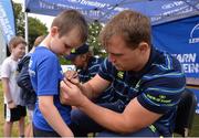 17 August 2016; Leinster Rugby's Rhys Ruddock signs an autograph for Robin Clarke, age 7, from Blackrock, at the Bank of Ireland Leinster Rugby Camp at Blackrock College RFC, Stradbrook Road, Blackrock, Co Dublin. Photo by Piaras Ó Mídheach/Sportsfile