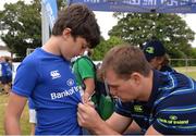 17 August 2016; Leinster Rugby's Rhys Ruddock signs an autograph for Harvey Liston, age 9, from Monkstown, at the Bank of Ireland Leinster Rugby Camp at Blackrock College RFC, Stradbrook Road, Blackrock, Co Dublin. Photo by Piaras Ó Mídheach/Sportsfile