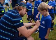 17 August 2016; Leinster Rugby's Jordi Murphy signs an autograph for Conor Reynolds, aged 6, from Killiney, at the Bank of Ireland Leinster Rugby Camp at Blackrock College RFC, Stradbrook Road, Blackrock, Co Dublin. Photo by Piaras Ó Mídheach/Sportsfile