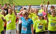 21 August 2016; RTÉ's Anne Cassin and participants warm up prior to the Jog For Jockeys in aid of Irish Injured Jockeys. Over 400 runners took part in the annual Jog For Jockeys 5km and 10km charity runs in aid of Irish Injured Jockeys at the Curragh Racecourse in Kildare today. Photo by Piaras Ó Mídheach/Sportsfile
