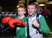 24 August 2016; Boxer Paddy Barnes with Joel Thomas, age 5, from Baldoyle, Co Dublin, at Dublin Airport as Team Ireland arrive home from the Games of the XXXI Olympiad at Dublin Airport in Dublin. Photo by Seb Daly/Sportsfile