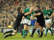 20 November 2010; Keith Earls, Ireland, is tackled by Richie McCaw and Tom Donnelly, right, New Zealand. Autumn International, Ireland v New Zealand, Aviva Stadium, Lansdowne Road, Dublin. Picture credit: Brendan Moran / SPORTSFILE
