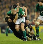 20 November 2010; Keith Earls, Ireland, is tackled by Richie McCaw, left, and Tom Donnelly, New Zealand. Autumn International, Ireland v New Zealand, Aviva Stadium, Lansdowne Road, Dublin. Picture credit: Matt Browne / SPORTSFILE