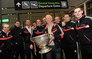 24 November 2010; Cork manager Conor Counihan and Cork players, from left, John Miskella, Alan Quirke, Nicholas Murphy, Donncha O'Connor, Aidan Walsh, Pearse O'Neill, Paudie Kissane, Paul Kerrigan, and Daniel Goulding, with the Sam Maguire cup, prior to departure for Kuala Lumpur ahead of the 2010 GAA Football All-Stars Tour, sponsored by Vodafone. Dublin Airport, Dublin. Picture credit: Brian Lawless / SPORTSFILE