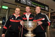 24 November 2010; Cork footballers, from left, John Miskella, Nicholas Murphy, and Aidan Walsh, with the Sam Maguire cup, prior to departure for Kuala Lumpur ahead of the 2010 GAA Football All-Stars Tour, sponsored by Vodafone. Dublin Airport, Dublin. Picture credit: Brian Lawless / SPORTSFILE