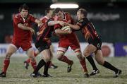 26 November 2010; James Coughlan, Munster, is tackled by Pat Leach and Ashley Smith, right, Dragons. Celtic League, Dragons v Munster, Rodney Parade, Newport, Wales. Picture credit: Steve Pope / SPORTSFILE