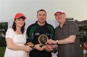 27 November 2010; Michael Wadding, from Waterford, who ran the line and acted as match referee for the last ten minutes, is presented with a trophy to mark the occasion by Uachtarán Chumann Lúthchleas Gael Criostóir Ó Cuana and Eileen Maher, Vodafone Ireland Fixed Services Director, Vodafone after the game. GAA Football All-Stars Tour 2009, sponsored by Vodafone, 2009 All-Stars v 2010 All-Stars, Royal Selangor Club, Bukit Kiara, Kuala Lumpur, Malaysia. Picture credit: Ray McManus / SPORTSFILE