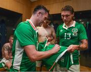 31 August 2016; Robbie Keane of Republic of Ireland signs jerseys for team-mates Jeff Hendrick and Callum O'Dowda in the team dressing room after the Three International Friendly game between the Republic of Ireland and Oman at the Aviva Stadium in Lansdowne Road, Dublin. Photo by David Maher/Sportsfile