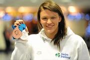 29 November 2010; Ireland's Grainne Murphy, from New Ross, Co. Wexford, on her arrival at Dublin Airport with her two bronze medals from the European Short Course Swimming Championships in the Netherlands. Dublin Airport, Dublin. Picture credit: Brendan Moran / SPORTSFILE