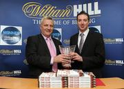 2 December 2010; &quot;The Club&quot; by Christy O'Connor has been announced as the 2010 William Hill Irish Sports Book of the Year. The Club is one of the finest books written on the subject of GAA and follows O'Connor's club, for whom he was goalkeeper, through a season in 2009 as they looked to revive past glories spurred on through personal losses and tragedy. This year’s shortlisted books included A Football Man by John Giles, Ruby by Ruby Walsh, Days of Heaven by Declan Lynch, My Story by Bernard Dunne, The Club by Christy O’Connor and Screaming at the Sky by Tony Griffin. Christy O'Connor is presented with his award by John Beresford, Head of William Hill Ireland, at the announcement. William Hill Bookmakers, Dame Street, Dublin. Picture credit: Brian Lawless / SPORTSFILE