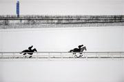 3 December 2010; A general view of two jockeys making their way across the sand gallop, which runs parallel to the M7 motorway, despite the freezing conditions at the Curragh Racecourse, Co. Kildare. Picture credit: Barry Cregg / SPORTSFILE