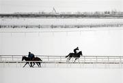 3 December 2010; A general view of jockeys saluting as they pass each other in freezing conditions on the sand Gallop at the Curragh Racecourse, Co. Kildare. Picture credit: Barry Cregg / SPORTSFILE