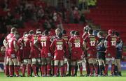 3 December 2010; Referee Nigel Owens, hidden, speaks to players from both teams after an altercation broke out between the two sides. Celtic League, Scarlets v Leinster, Parc Y Scarlets, Llanelli, Wales. Picture credit: Steve Pope / SPORTSFILE