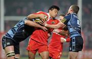 4 December 2010; Lifeimi Mafi, Munster, is tackled by Mike Paterson, left, and Richie Rees, Cardiff Blues. Celtic League, Munster v Cardiff Blues, Thomond Park, Limerick. Picture credit: Brendan Moran / SPORTSFILE