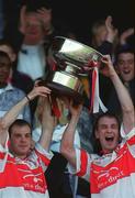 15 July 2001; Derry captain Colin McEldowney, right, lifts the cup with team-mate Emmet McKeever, last years Captain, who was suspended which resulted in him missing the opportunity to lift the cup when Derry won the 2000 Ulster Hurling Final, following their victory in the Guinness Ulster Senior Hurling Championship Final match between Derry and Down at Casement Park in Belfast. Photo by Aoife Rice/Sportsfile