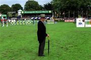 10 August 2001; An official inspects the course prior to the Kerrygold Nations Cup at the Kerrygold Horse Show at the RDS in Dublin. Photo by Brian Lawless/Sportsfile
