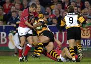 7 September 2001; Rod Snow of Newport is tackled by Jason Holland, left, and Dominic Crotty of Munster during the Celtic League Pool B match between Munster and Newport Dragons at Musgrave Park in Cork. Photo by Brendan Moran/Sportsfile