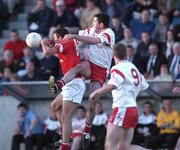 9 September 2001; Tom Kenny of Cork in action against Peter Donnelly of Tyrone during the All-Ireland Under 21 Football Championship Semi-Final match between Tyrone and Cork at Parnell Park in Dublin. Photo by David Maher/Sportsfile
