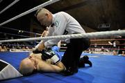 10 December 2010; Referee Emile Tiedt attends to Andrejs Suliko after a knockout in the first round against Robbie Long, during their Super Middleweight title bout. Dolphil Promotions Fight Night - The Prides Path to Glory - Undercard, National Basketball Arena, Tallaght, Dublin. Picture credit: David Maher / SPORTSFILE