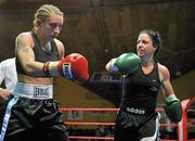 10 December 2010; Christina McMahon, right, in action against Polina Teucheva, during their Bantamweight title bout. Dolphil Promotions Fight Night - The Prides Path to Glory - Undercard, National Basketball Arena, Tallaght, Dublin. Picture credit: David Maher / SPORTSFILE