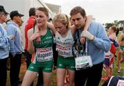 12 December 2010; Ciara Mageean, Ireland, helps team-mate Emma Mitchell after the Women's Junior race. 17th SPAR European Cross Country Championships, Albufeira, Portugal. Picture credit: Brendan Moran / SPORTSFILE