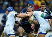 12 December 2010; Jamie Heaslip, Leinster, is tackled by Julien Bonnaire, left, and Gonzalo Canale, ASM Clermont Auvergne. Heineken Cup Pool 2 - Round 3, ASM Clermont Auvergne v Leinster, Stade Marcel Michelin, Clermont, France. Picture credit: Stephen McCarthy / SPORTSFILE