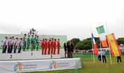 12 December 2010; The Ireland U23 men's team, having been presented with their gold medals, stand for the playing of Amhrann na bhFiann as the Irish tricolour is raised during the presentation of the team medals for the Men's U23 race. 17th SPAR European Cross Country Championships, Albufeira, Portugal. Picture credit: Brendan Moran / SPORTSFILE