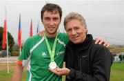 12 December 2010; Eamonn Coghlan with his son John and the team gold medal John won in the Men's U23 race. 17th SPAR European Cross Country Championships, Albufeira, Portugal. Picture credit: Brendan Moran / SPORTSFILE
