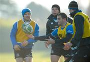 14 December 2010; Leinster's David Kearney in action during squad training ahead of their Heineken Cup, Pool 2, Round 4, game against ASM Clermont Auvergne on Saturday, while being watched on by Gordon D'Arcy, left, Shane Jennings and Jonathan Sexton, right. Leinster Rugby media briefing and squad training, Thornfields, UCD, Belfield, Dublin. Photo by Sportsfile