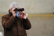 15 December 2010; A punter uses his binoculars to see the betting prices on the big screen before The John Durkan Memorial Punchestown Steeplechase. Fairyhouse Racecourse, Fairyhouse, Co. Meath. Picture credit: Barry Cregg / SPORTSFILE