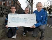 17 December 2010; Jim Augney, Race Director, Lifestyle Sports - Adidas Dublin City Marathon presents Special Olympics athletes Gary O'Brien, left, from Artane, Co. Dublin, and James Murphy, from Portmarnock, Co. Dublin, with a cheque for €6000, money raised as a result of this year’s Lifestyle Sports - Adidas Dublin City Marathon. Special Olympics Ireland was one of two nominated charities to benefit from this year’s marathon. Special Olympics Ireland, Park House, North Circular Road, Dublin. Photo by Sportsfile