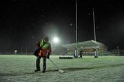 17 December 2010; Michael Guest, a member of the groundstaff, clears the snow off the end line before the start of the game. Amlin Challenge Cup, Pool 1, Round 3, Connacht v Harlequins, Sportsground, Galway. Picture credit: David Maher / SPORTSFILE