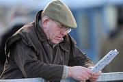 18 December 2010; Oliver Wall from Co. Meath reads the card before The Christmas Cracker Handicap Hurdle. Navan Racecourse, Proudstown, Navan, Co. Meath. Picture credit: Barry Cregg / SPORTSFILE