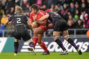 18 December 2010; Tony Buckley, Munster, is tackled by Richard Hibbard, left, and Mike Phillips, Ospreys. Heineken Cup, Pool 3, Round 4, Ospreys v Munster, Liberty Stadium, Swansea, Wales. Picture credit: Stephen McCarthy / SPORTSFILE