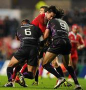 18 December 2010; David Wallace, Munster, is tackled by Jerry Collins, left, and Mike Phillips, Ospreys. Heineken Cup, Pool 3, Round 4, Ospreys v Munster, Liberty Stadium, Swansea, Wales. Picture credit: Stephen McCarthy / SPORTSFILE