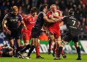 18 December 2010; Mick O'Driscoll, Munster, is tackled by Mike Phillips, left, and Marty Holah, Ospreys. Heineken Cup, Pool 3, Round 4, Ospreys v Munster, Liberty Stadium, Swansea, Wales. Picture credit: Stephen McCarthy / SPORTSFILE