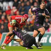 18 December 2010; Sam Tuitupou, Munster, is tackled by Mike Phillips, Ospreys. Heineken Cup, Pool 3, Round 4, Ospreys v Munster, Liberty Stadium, Swansea, Wales. Picture credit: Stephen McCarthy / SPORTSFILE