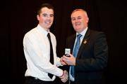 19 December 2010; Dublin's Gary Sweeney is presented with his All-Ireland U-21 medal by Uachtarán CLG Criostóir Ó Cuana. The Officers Mess, Baldonnell, Dublin. Picture credit: Barry Cregg / SPORTSFILE